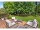 Inviting backyard with a cozy fire pit and comfortable seating on a wooden deck at 431 Shore Dr, Suwanee, GA 30024
