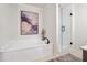 Bright bathroom featuring a modern tub, sleek fixtures, and a separate glass shower at 431 Shore Dr, Suwanee, GA 30024