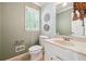 Stylish half bathroom featuring patterned wallpaper, window shutter and modern fixtures at 431 Shore Dr, Suwanee, GA 30024