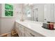 Bathroom with long vanity, large mirror, and window providing natural light at 431 Shore Dr, Suwanee, GA 30024