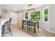 Eat-in area features modern lighting, backyard view, and access to a breakfast bar and pantry at 431 Shore Dr, Suwanee, GA 30024