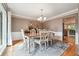 Bright dining room featuring hardwood floors, white chairs, and a chandelier over a wooden table at 431 Shore Dr, Suwanee, GA 30024