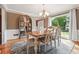 Elegant dining room with hardwood floors, a decorative china cabinet, and natural light from large windows at 431 Shore Dr, Suwanee, GA 30024