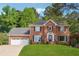 Charming two-story brick home with a well-manicured lawn and attached two car garage at 431 Shore Dr, Suwanee, GA 30024