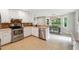 Bright kitchen with stainless steel appliances, white cabinets, and an eat-in area at 431 Shore Dr, Suwanee, GA 30024
