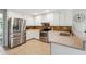 Modern kitchen with stainless steel appliances, white cabinets, and tile backsplash at 431 Shore Dr, Suwanee, GA 30024