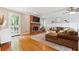 Bright living room with hardwood floors, a fireplace, a large sofa, and natural light at 431 Shore Dr, Suwanee, GA 30024