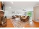 A spacious living room featuring hardwood floors, a fireplace, and a large sectional sofa at 431 Shore Dr, Suwanee, GA 30024