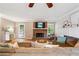 Inviting living room with a brick fireplace, plush sofa, and a ceiling fan at 431 Shore Dr, Suwanee, GA 30024