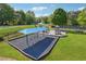 Fenced in playground with swings, slides, and climbing equipment on a lush green lawn at 431 Shore Dr, Suwanee, GA 30024