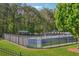 Well-maintained tennis courts with fencing and mature trees surrounding the perimeter at 431 Shore Dr, Suwanee, GA 30024