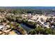 A beautiful aerial view of the neighborhood homes, a pond, and mature trees in a residential setting at 5447 Stirrup Way, Powder Springs, GA 30127