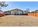 Large fenced backyard showing the back of a home with a covered patio at 5447 Stirrup Way, Powder Springs, GA 30127