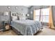 Comfortable bedroom with plush bedding, stylish side tables, and bright windows offering natural light at 5447 Stirrup Way, Powder Springs, GA 30127