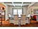 Elegant dining room with hardwood floors, coffered ceiling and ample seating for gatherings at 5447 Stirrup Way, Powder Springs, GA 30127