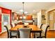 Dining area with a wood table and the kitchen in the background at 5447 Stirrup Way, Powder Springs, GA 30127