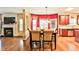 Dining area with a wood table and a fireplace on the left side at 5447 Stirrup Way, Powder Springs, GA 30127