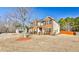 Charming two-story home with a well-maintained lawn and mature trees in a suburban setting at 5447 Stirrup Way, Powder Springs, GA 30127