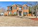 Beautiful two-story brick home with manicured lawn and black shutters on a sunny day at 5447 Stirrup Way, Powder Springs, GA 30127