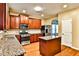 Well-equipped kitchen featuring granite countertops, stainless steel appliances, and wood cabinets at 5447 Stirrup Way, Powder Springs, GA 30127