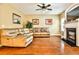 Comfortable living room featuring a fireplace and a brown leather couch at 5447 Stirrup Way, Powder Springs, GA 30127