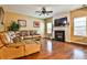 Comfortable living room featuring a fireplace and a brown leather couch at 5447 Stirrup Way, Powder Springs, GA 30127