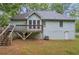 View of backyard, deck, siding, and basement access at 865 Turner Dr, Lawrenceville, GA 30046