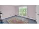 Bedroom features large window with view of outside, light pink walls, and soft carpet at 865 Turner Dr, Lawrenceville, GA 30046