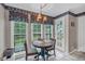 Cozy breakfast nook featuring a round table, backyard views, and quaint decor at 865 Turner Dr, Lawrenceville, GA 30046