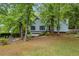 Charming home with light-blue siding, a welcoming front yard and mature trees offering great shade at 865 Turner Dr, Lawrenceville, GA 30046