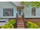 Inviting front entrance with brick steps and a blue front door with decorative trim at 865 Turner Dr, Lawrenceville, GA 30046