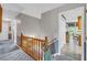 Second story hallway with carpet, wallpaper, wood railing, and views of other rooms at 865 Turner Dr, Lawrenceville, GA 30046