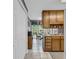 Efficient kitchenette with wood cabinetry and a view into the breakfast nook at 865 Turner Dr, Lawrenceville, GA 30046