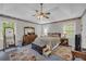 Comfortable main bedroom featuring a carpet floor, tray ceiling, and plenty of light at 865 Turner Dr, Lawrenceville, GA 30046