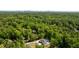 An aerial view reveals a stunning property surrounded by lush greenery with a skyline view at 5260 Long Island Nw Dr, Atlanta, GA 30327