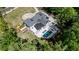 An aerial view shows a gorgeous home with a manicured lawn and pool surrounded by trees at 5260 Long Island Nw Dr, Atlanta, GA 30327