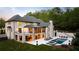 Luxury home with outdoor pool, lounge area, and landscaped yard at 5260 Long Island Nw Dr, Atlanta, GA 30327