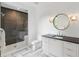 Modern bathroom with tiled floors, a glass shower, and a large vanity with a round mirror at 5260 Long Island Nw Dr, Atlanta, GA 30327