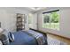 Bedroom with view of backyard, tray ceilings, and sports-themed decor at 5260 Long Island Nw Dr, Atlanta, GA 30327