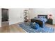 Well-lit bedroom featuring a dark wood bedframe, sports decor, and a modern bathroom at 5260 Long Island Nw Dr, Atlanta, GA 30327