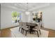 Elegant dining room with modern chandelier, large windows, and stylish furniture on neutral carpet at 5260 Long Island Nw Dr, Atlanta, GA 30327