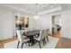 Refined dining room with sleek oval table, neutral chairs, modern lighting, and large artwork at 5260 Long Island Nw Dr, Atlanta, GA 30327