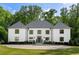 Stately white brick home exterior with dark-framed windows and well-manicured landscaping at 5260 Long Island Nw Dr, Atlanta, GA 30327