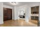 Grand foyer with hardwood floors and bar area, leading into a dining room, offering an inviting entrance at 5260 Long Island Nw Dr, Atlanta, GA 30327