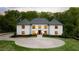 Elegant two-story home featuring a circular driveway, manicured lawn, and classic architectural details at 5260 Long Island Nw Dr, Atlanta, GA 30327