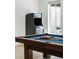 Close-up of a pool table and arcade game in a well-lit recreational area at 5260 Long Island Nw Dr, Atlanta, GA 30327