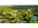 Aerial view of a community golf course and tennis courts surrounded by mature trees, and a city skyline in the distance at 5260 Long Island Nw Dr, Atlanta, GA 30327