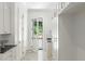 Bright hallway features white cabinetry, black countertops, and a glass paneled door to the home's exterior at 5260 Long Island Nw Dr, Atlanta, GA 30327