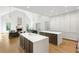 Open-concept kitchen with double islands, fireplace, hardwood floors, and stainless appliances at 5260 Long Island Nw Dr, Atlanta, GA 30327