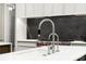 Modern kitchen sink with stainless steel faucet and views of the Wolf oven at 5260 Long Island Nw Dr, Atlanta, GA 30327